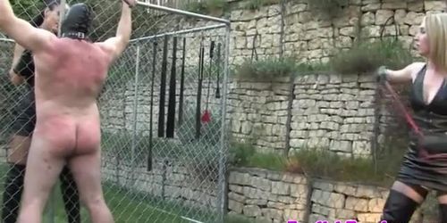 Femdom harshly punish sub with whips outdoor